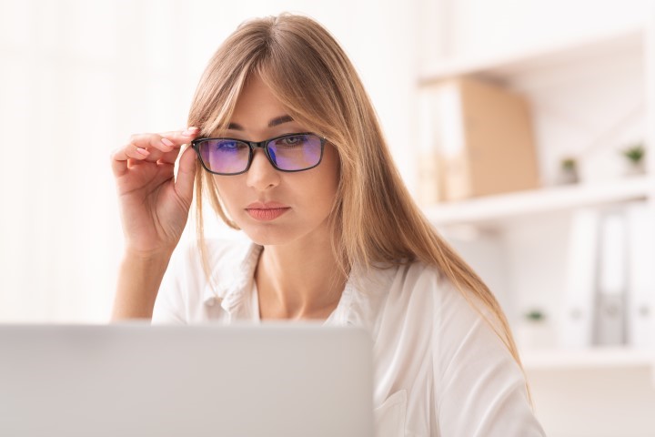 Eyesight Problem. Businesswoman Looking Through Eyeglasses At Laptop Screen Sitting In Office. Selective Focus